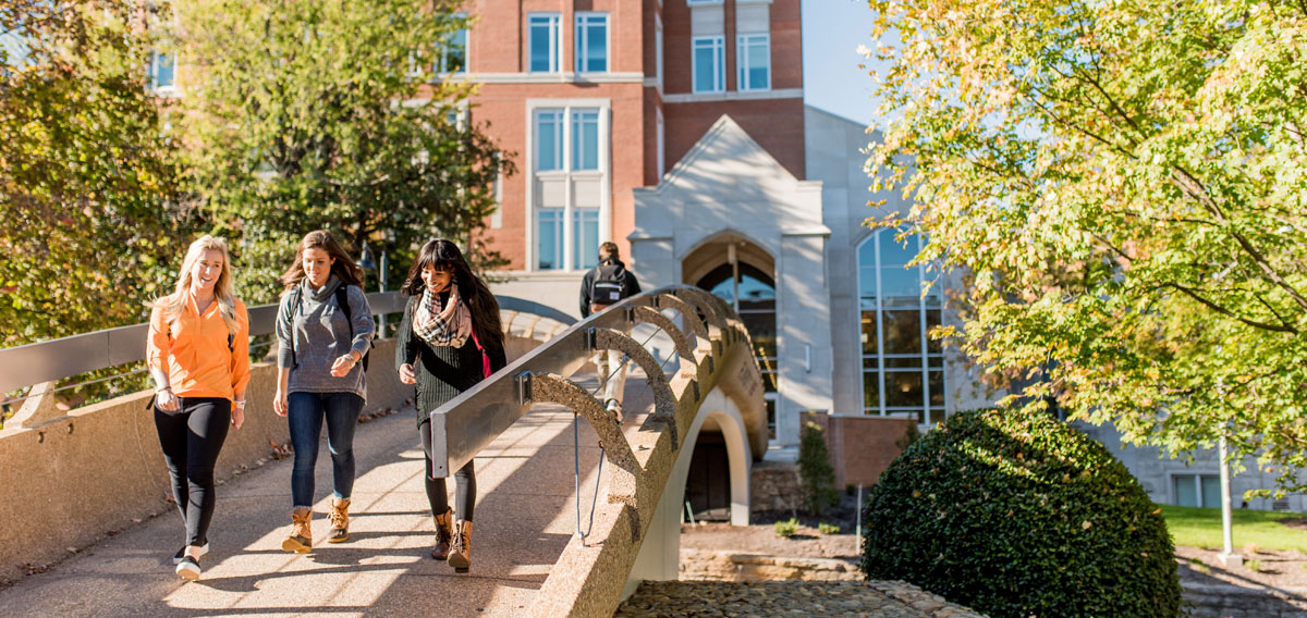 UT Students walking across pedestrian bridge
